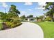 Landscaped curb appeal with a circular driveway at 301 Aurora E St, Venice, FL 34285