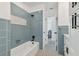 Renovated bathroom with blue tile, a new tub, and modern vanity at 301 Aurora E St, Venice, FL 34285