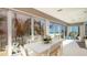 Dining area with ocean views, white table and seating, plus lots of natural light at 107 Elm Ave, Anna Maria, FL 34216