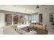 Bright living room with comfortable white sofas and sliding glass doors boasting ocean views at 107 Elm Ave, Anna Maria, FL 34216