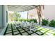 Outdoor patio area featuring seating, a fire pit, and lush landscaping at 107 Elm Ave, Anna Maria, FL 34216