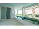 Luxury pool area with seating area and direct access to the beautiful garden at 107 Elm Ave, Anna Maria, FL 34216