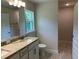 Bathroom featuring double granite vanity and ample natural light at 4012 Oscar Ter, North Port, FL 34286