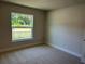 Bright bedroom with a large window that overlooks the outdoors at 4012 Oscar Ter, North Port, FL 34286