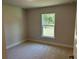 Bedroom with a window providing natural light and views of outdoor greenery at 4012 Oscar Ter, North Port, FL 34286