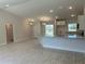 A open concept kitchen and living area features granite countertops, recessed lighting, and tile flooring at 4012 Oscar Ter, North Port, FL 34286