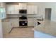 Bright kitchen features granite counters, stainless appliances, and stylish wood look flooring at 4012 Oscar Ter, North Port, FL 34286