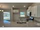 Granite countertops, white cabinets, stainless steel appliances, and tile flooring are featured in this kitchen at 4012 Oscar Ter, North Port, FL 34286