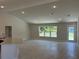 An expansive living room features new tile flooring, recessed lighting, and a view to the green outdoors at 4012 Oscar Ter, North Port, FL 34286