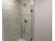Modern shower featuring sleek tile, a glass door, and a rainfall shower head at 4012 Oscar Ter, North Port, FL 34286
