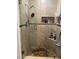 Shower with glass enclosure, built-in shelves and pebble floor at 4540 Tippecanoe Trl # 183, Sarasota, FL 34233