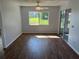 Bright living room with vinyl flooring and sliding glass doors to the patio at 4540 Tippecanoe Trl # 183, Sarasota, FL 34233