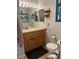 Bathroom with wood vanity, toilet and large mirror at 4540 Tippecanoe Trl # 183, Sarasota, FL 34233