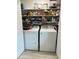 Laundry room with washer, dryer, and ample storage shelves at 4540 Tippecanoe Trl # 183, Sarasota, FL 34233