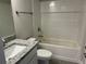 Modern bathroom showcasing granite vanity top, white cabinets, and tiled bath-shower combo at 4860 Florida Rd, Venice, FL 34293