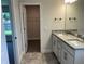 Double granite vanity in a bathroom with stylish tile flooring and a walk-in closet at 4860 Florida Rd, Venice, FL 34293