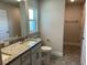 Well-lit bathroom features granite countertop vanity, white cabinets, and neutral tile flooring at 4860 Florida Rd, Venice, FL 34293