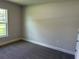Bedroom featuring neutral carpet and plenty of natural light from a large window at 4860 Florida Rd, Venice, FL 34293