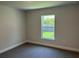 Cozy bedroom with neutral carpet and ample natural light from a large window at 4860 Florida Rd, Venice, FL 34293