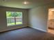 Bright bedroom featuring plush carpeting and a large window, ready for personalization at 4860 Florida Rd, Venice, FL 34293