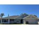 Charming single-story home featuring a well-manicured lawn, gray exterior, and attached two-car garage at 4860 Florida Rd, Venice, FL 34293