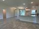 Open concept living area with view of kitchen with granite countertops and breakfast bar at 4860 Florida Rd, Venice, FL 34293