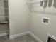 Functional laundry room with tile flooring, wire shelving, and convenient washer hookups at 4860 Florida Rd, Venice, FL 34293
