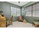 Cozy den with neutral walls, paneled accenting, comfortable chairs and two windows at 5635 Spanish Point Ct, Palmetto, FL 34221
