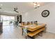 Open dining area features a large table, sliding glass doors, and abundant natural light at 5635 Spanish Point Ct, Palmetto, FL 34221