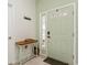 Welcoming entryway featuring a light green door and accent table with decorative basket at 5635 Spanish Point Ct, Palmetto, FL 34221