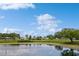 Scenic view of community pond surrounded by lush trees and beautiful landscaping at 5635 Spanish Point Ct, Palmetto, FL 34221
