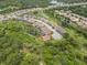 Expansive aerial view of a charming home nestled within a lush, green landscape and a vibrant neighborhood at 6600 Dovekey Dr, Sarasota, FL 34241