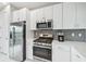 Modern kitchen with stainless steel appliances and white cabinetry at 5244 Barnett Cir, Lakewood Ranch, FL 34211