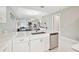 Modern kitchen with white cabinets, stainless steel appliances and island at 5244 Barnett Cir, Lakewood Ranch, FL 34211