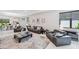 Open concept living room with leather sofas and large TV at 5244 Barnett Cir, Lakewood Ranch, FL 34211
