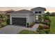 Single-story house with a gray garage door and walkway at 5244 Barnett Cir, Lakewood Ranch, FL 34211