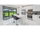 Modern kitchen with white cabinets, stainless steel appliances, and island at 5244 Barnett Cir, Lakewood Ranch, FL 34211