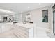 Modern kitchen with white island, stainless steel appliances, and view to backyard at 5244 Barnett Cir, Lakewood Ranch, FL 34211