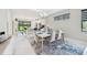 Modern dining room with white table and blue accents at 5244 Barnett Cir, Lakewood Ranch, FL 34211