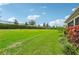 Expansive grassy backyard with a sloped lawn and fence at 5244 Barnett Cir, Lakewood Ranch, FL 34211