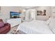 Comfortable bedroom with TV, dresser, and access to bathroom at 5244 Barnett Cir, Lakewood Ranch, FL 34211