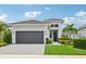 Modern single-story home with two-car garage and landscaped yard at 5244 Barnett Cir, Lakewood Ranch, FL 34211