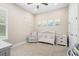 Bedroom with crib, armchair, and calming decor at 6600 Dovekey Dr, Sarasota, FL 34241