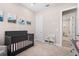 Bedroom with crib, bookshelf, and access to another room at 6600 Dovekey Dr, Sarasota, FL 34241