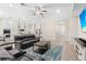 Open living area with sectional sofa and large TV at 6600 Dovekey Dr, Sarasota, FL 34241