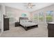 Spacious bedroom with large windows and ceiling fan at 6600 Dovekey Dr, Sarasota, FL 34241