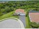Aerial view showcasing a beautiful home with a well-manicured lawn and driveway at 6600 Dovekey Dr, Sarasota, FL 34241