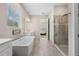 Elegant bathroom with soaking tub, walk-in shower, and double vanity at 6600 Dovekey Dr, Sarasota, FL 34241