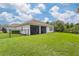 Screened patio and expansive grassy backyard, perfect for outdoor entertainment at 6600 Dovekey Dr, Sarasota, FL 34241