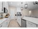 Modern kitchen featuring white cabinets, an island, and stainless steel appliances at 6600 Dovekey Dr, Sarasota, FL 34241